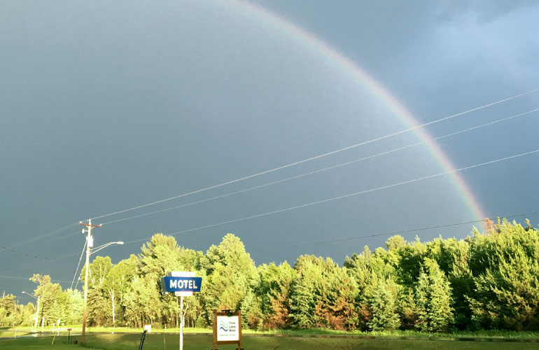 three lakes motel in michigamme mi with rainbow over the sky
